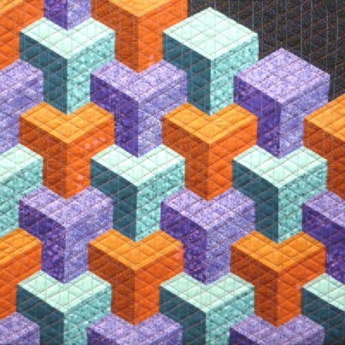 Box & Cox quilt pattern by Little Patch Pockets featuring a 3D geometric design in orange, purple and turquoise fabrics