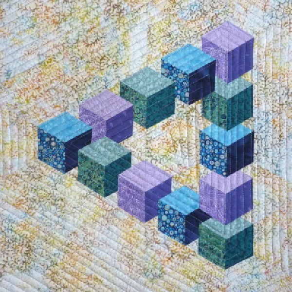 Penrose Triangle quilt by Little Patch Pockets featuring a 3D geometric design in blue, purple and green