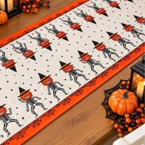 Halloween table runner with pumpkin skeletons, stars, moons and orange spiderweb border