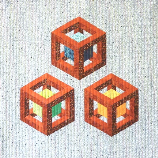 Treasure Boxes quilt pattern by Little Patch Pockets featuring three-dimensional geometric box blocks in orange and colourful fabrics